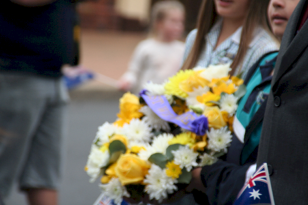Girl carrying one of the many wreaths