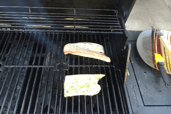 Close up of grill marked fish fillets turned once. Repeat second time, turning fillets, the opposite direction. 